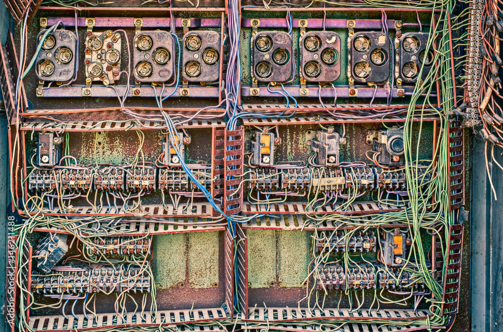 Old broken switchboard in interior of destroyed manufacturing plant