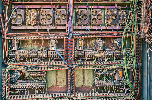 Old broken switchboard in interior of destroyed manufacturing plant