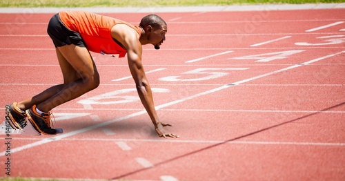 Full length of sport runner at start line