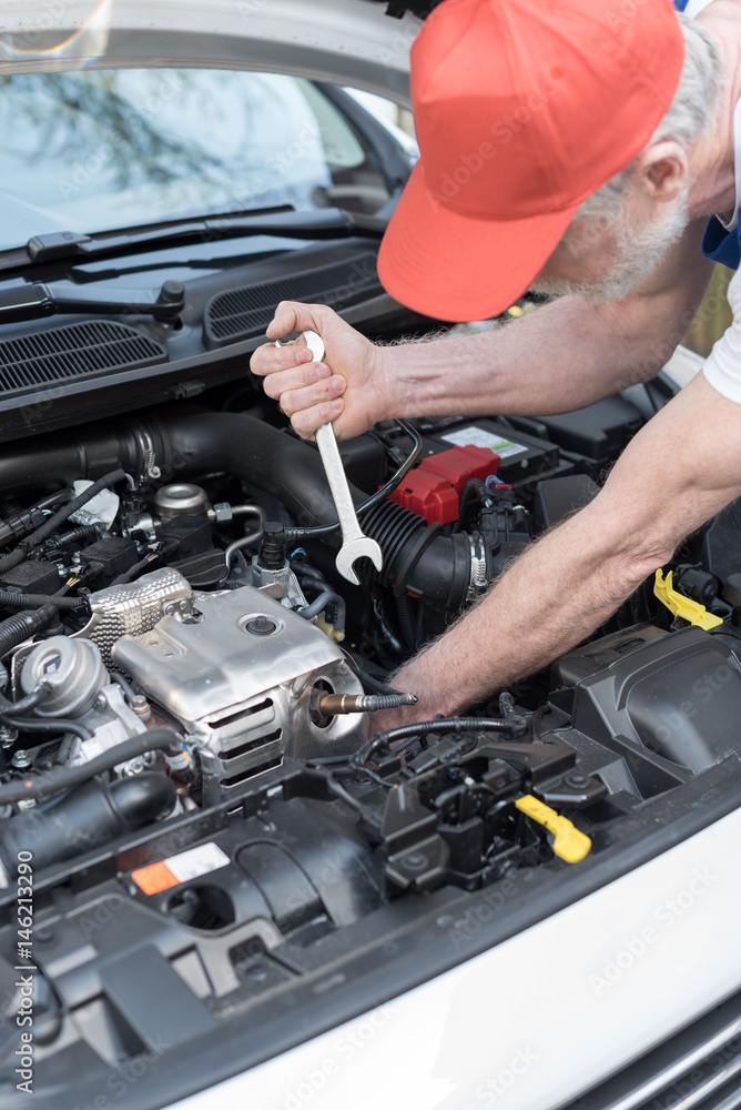 Car mechanic working on car engine Car mechanic working on car engine