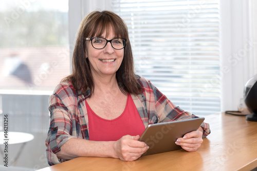 Mature woman using a tablet photo