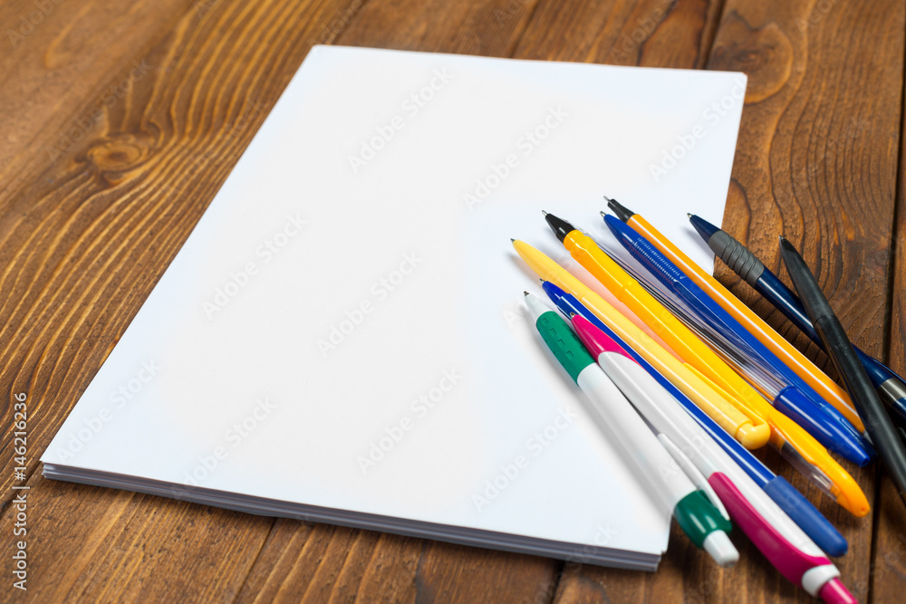 Blank Papers and Pen on Wooden Table Blank Papers and Pen on Wooden Table