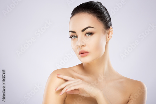 Beautiful girl with nude make up at studio background