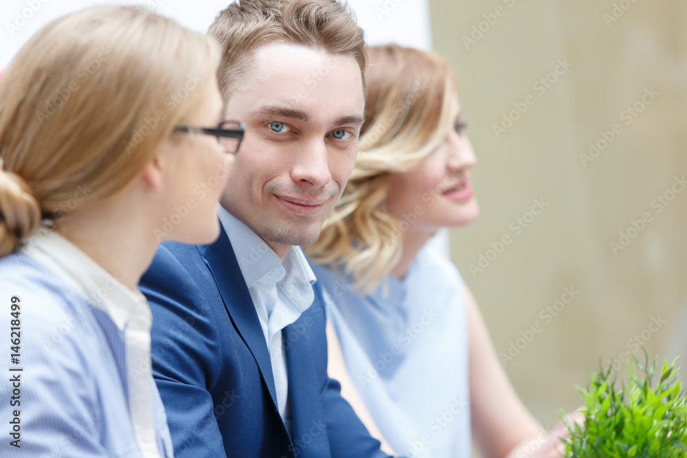 Businessman with colleagues in the background in office Businessman with colleagues in the background in office