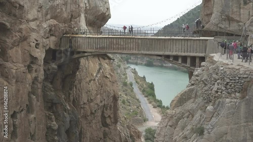 Walkers in 'El Caminito del Rey' with final bridge, static camera
