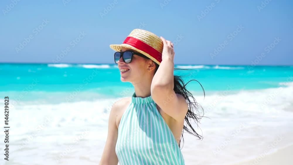 Beautiful woman on summer holidays smiling happy on white beach. Happy girl walking in summer dress. SLOW MOTION Beautiful woman on summer holidays smiling happy on white beach. Happy girl walking in summer dress. SLOW MOTION