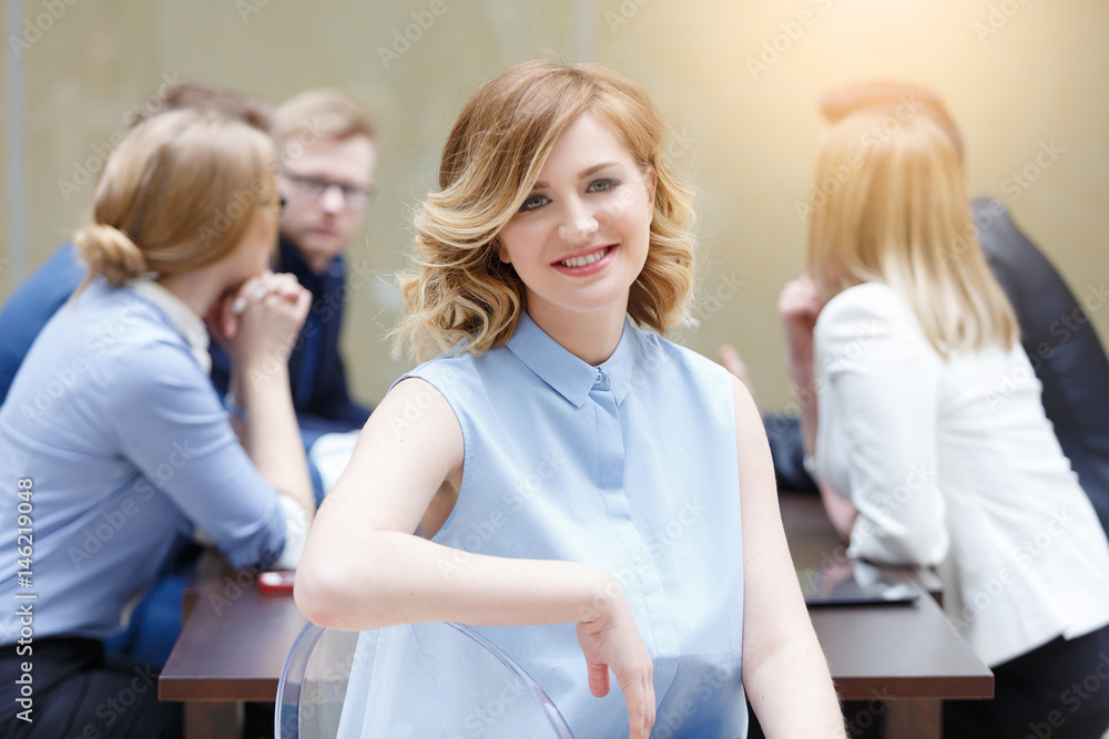 Face of beautiful woman on the background of business people Face of beautiful woman on the background of business people