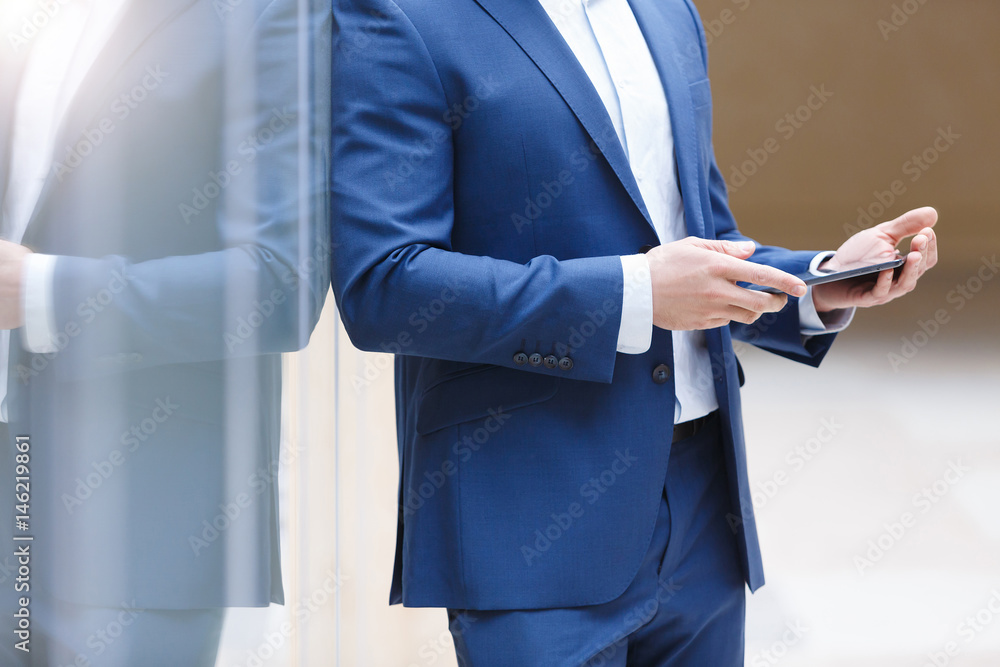 Handsome positive young businessman in modern office