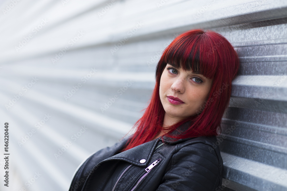 Fototapeta premium Portrait of a young woman, model of fashion in urban background