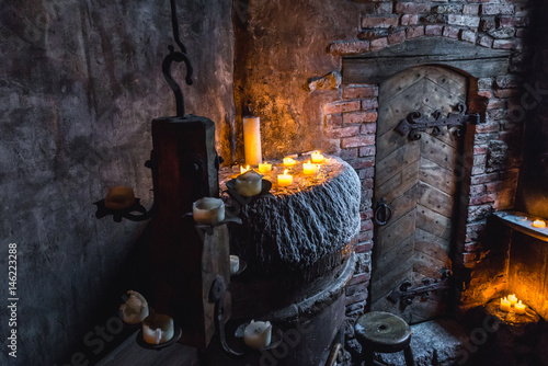 Medieval style interior with old wooden doors and candles