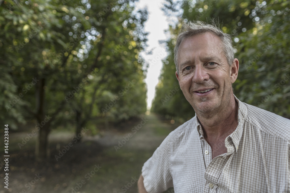 Portrait of smiling Caucasian man in orchard Portrait of smiling Caucasian man in orchard
