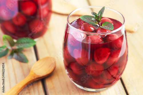 Bilde på lerret Sour cherry compote dessert served with mint leaves