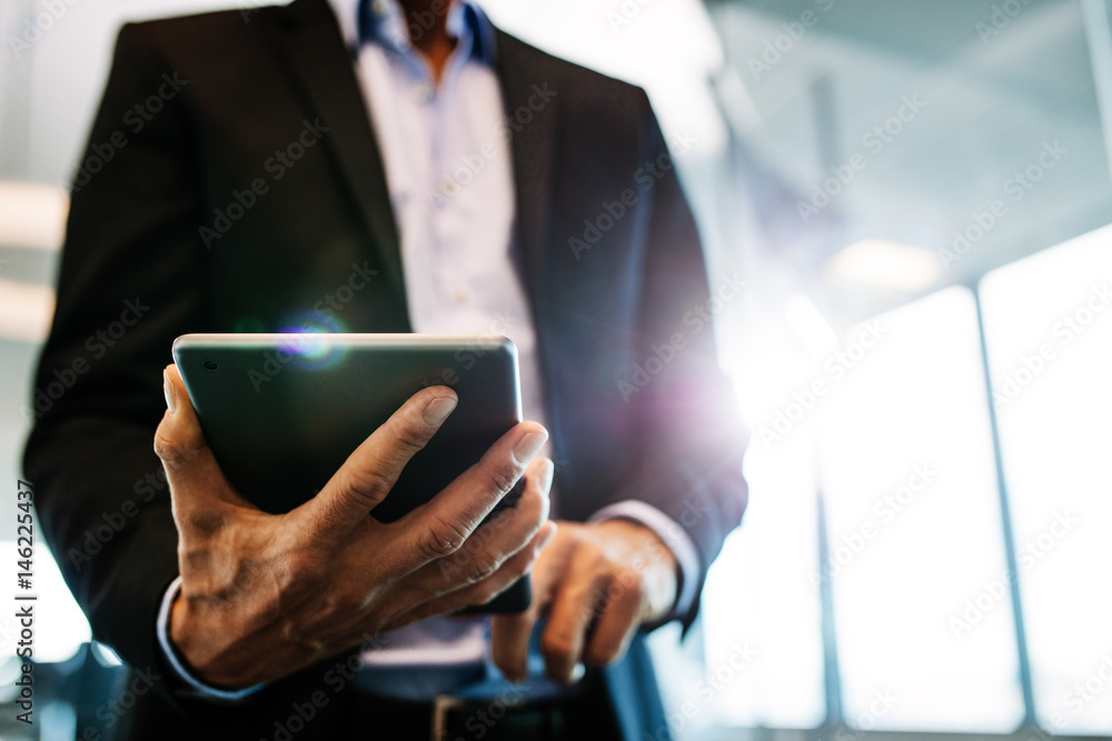 Businessman working on digital tablet in office Businessman working on digital tablet in office