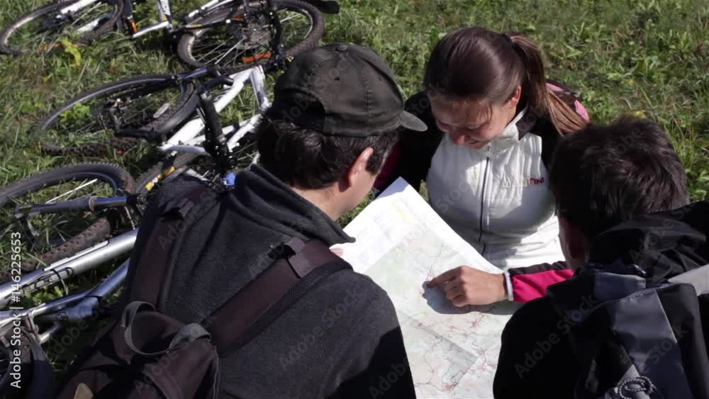 Tourists on cycling trip looking on map Tourists on cycling trip looking on map