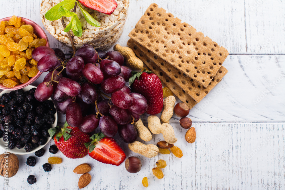 Healthy snacks on white wooden table