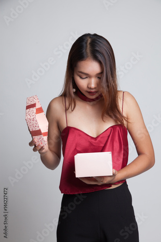 Young Asian woman open a gift box. © halfbottle