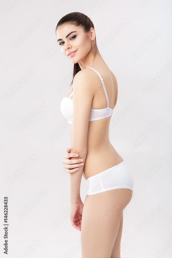 portrait of young beautiful woman brunette with natural makeup in white lingerie - obrazy, fototapety, plakaty 