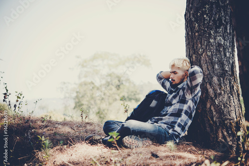 Men hiking sitting relax and sleeping in pine forest.