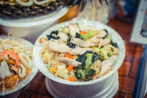 Rice with chicken, seafood and vegetables. Night food market, Thailand. photo