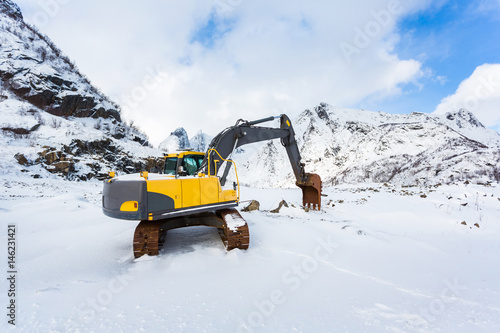 Excavator in the snowy mountains