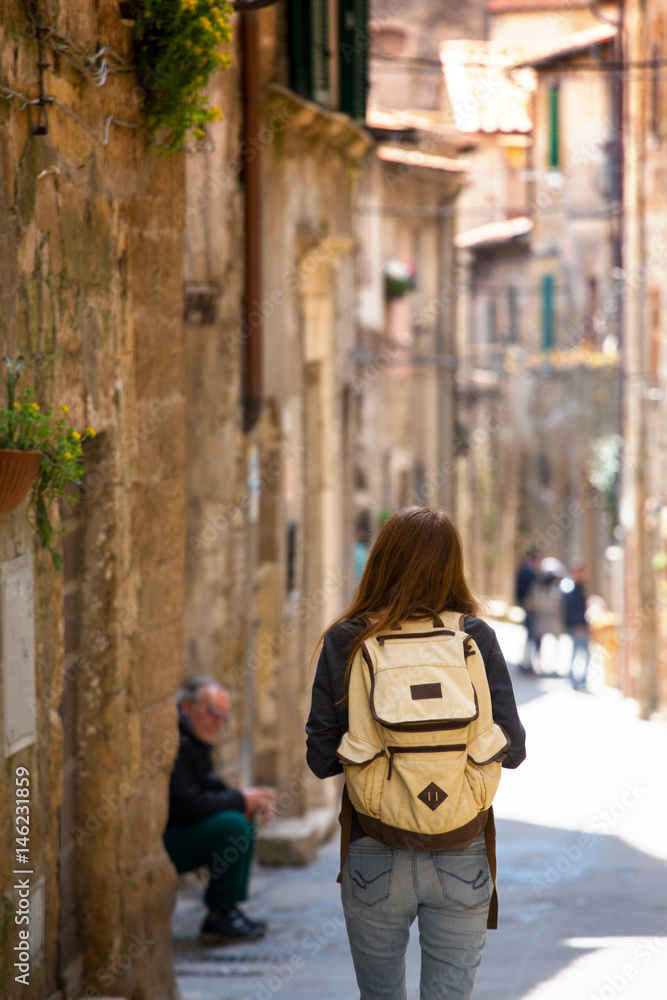 Girl tourist walking in the old city Girl tourist walking in the old city