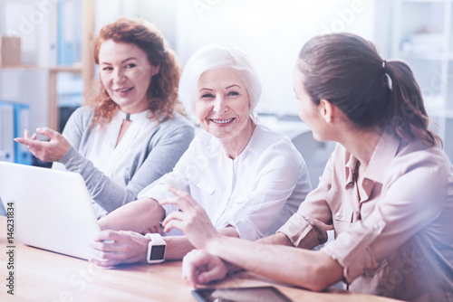 Pretty elderly female looking at her secretary