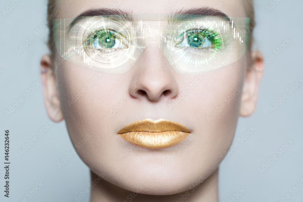 Young woman looking with futuristic smart glasses. Beautiful and attractive girl with gold make-up from future in process of scanning. Virtual hologram on her high tech glasses Young woman looking with futuristic smart glasses. Beautiful and attractive girl with gold make-up from future in process of scanning. Virtual hologram on her high tech glasses