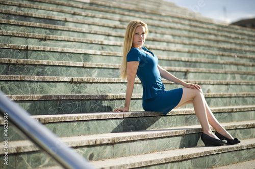 Portrait of a young beautiful blonde woman in a urban background