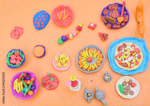 Children dazzled from plasticine dishes and food