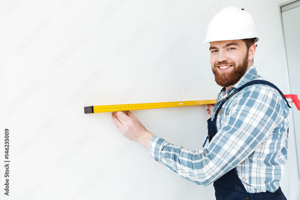 Man holding ruler and looking camera Man holding ruler and looking camera