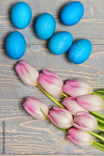 Fototapeta Naklejka Na Ścianę i Meble -  traditional eggs painted in blue color with pink beautiful tulips