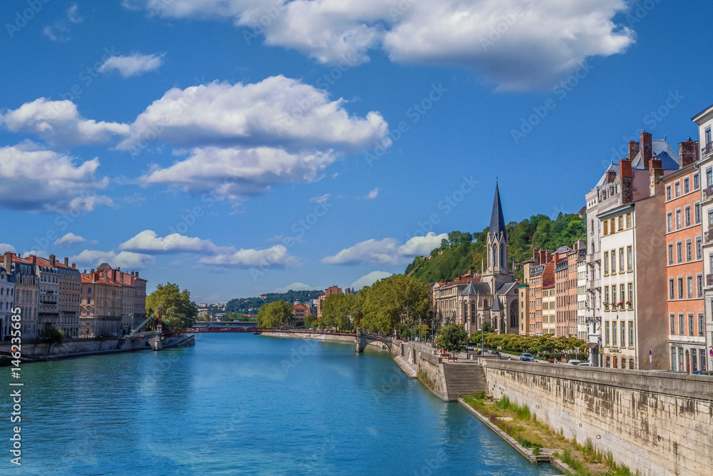 The river Saone view with Church of Saint Georges and footbridge in the city center of Lyon, France