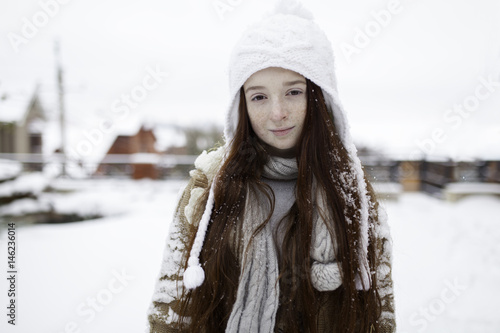 Portrait of Caucasian girl outdoors in snow photo