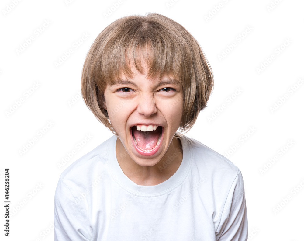 Close-up emotional portrait of attractive angry child teenager girl screaming wide open mouth. Funny cute child, isolated on white background. Negative human face expression. Conflict concept. Close-up emotional portrait of attractive angry child teenager girl screaming wide open mouth. Funny cute child, isolated on white background. Negative human face expression. Conflict concept.