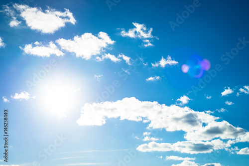 Clouds in the sky. Blue sky background with clouds and sun.