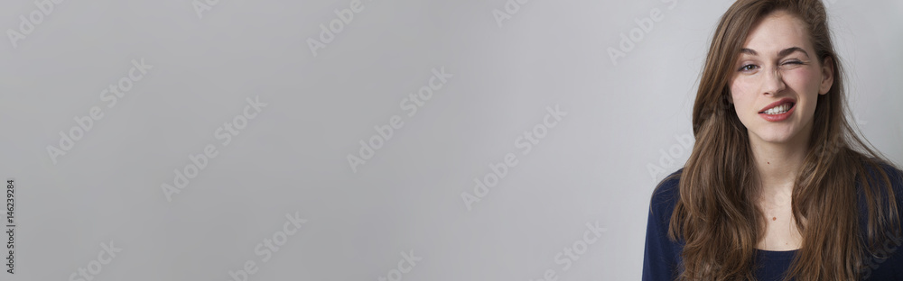 wink, fun and expression concept with playful young woman wink, fun and expression concept with playful young woman
