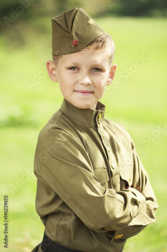 Little boy in military uniform of the Soviet Army