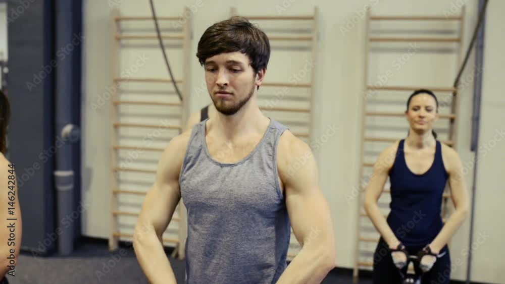 Young people in crossfit gym lifting kettlebells Young people in crossfit gym lifting kettlebells