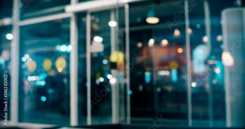 Automatic door of modern city mall working defocused footage, vintage grading.