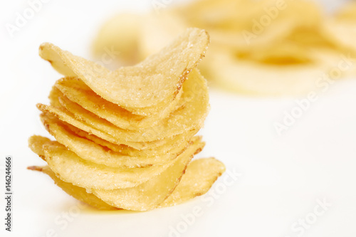 Crispy potato chips isolated on white background close-up