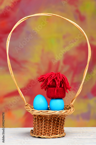 easter holiday  blue smurfs eggs in red hat in basket