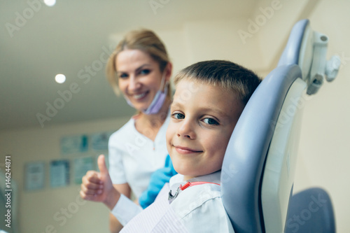 Little cute boy at the dentist looking at the camera and smiling