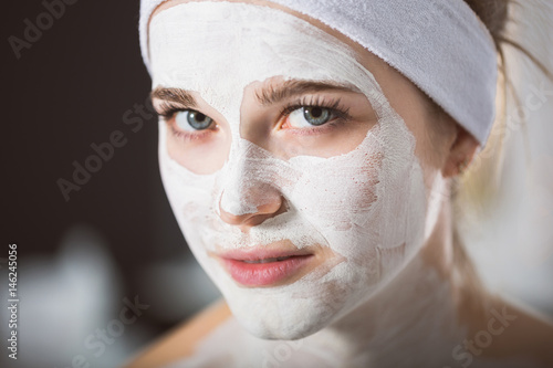 Young woman at enzymatic peeling therapy in spa