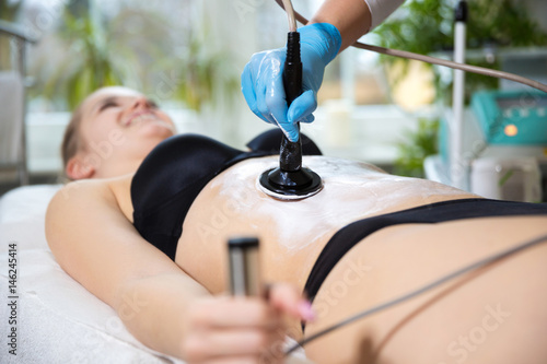 Woman at beautician's getting thermaslim lavatron therapy photo