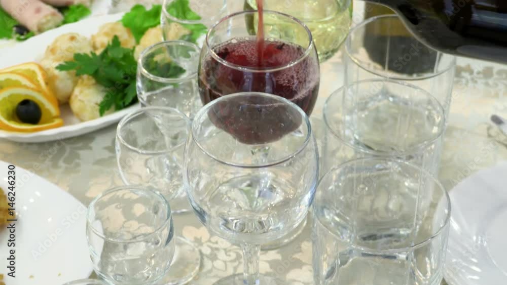 Waiter pouring red wine from bottle into glasses. Footage 4K, Ultra HD, UHD Waiter pouring red wine from bottle into glasses. Footage 4K, Ultra HD, UHD