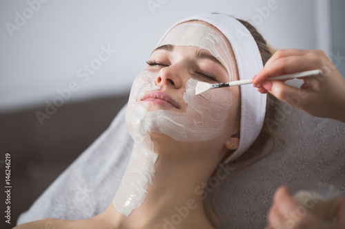 Woman getting enzymatic peeling at beautician's photo