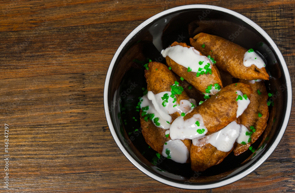 Fried Ravioli with Sauce on a wooden background. with copy space. top view Fried Ravioli with Sauce on a wooden background. with copy space. top view