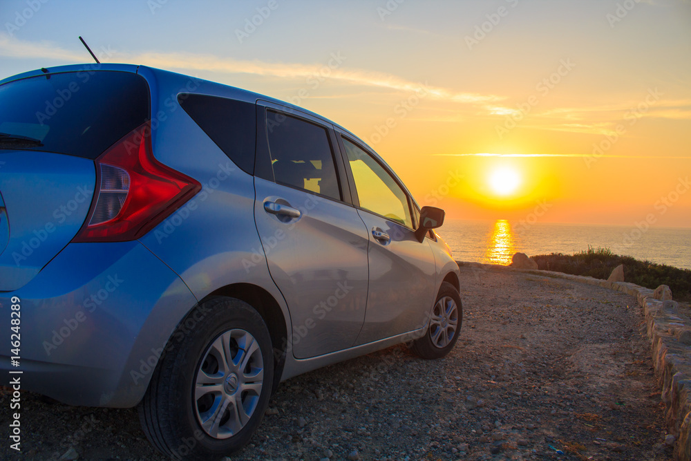 a car at the sea on sunset background.
