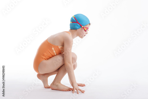 The girl is sitting in a swimming suit
