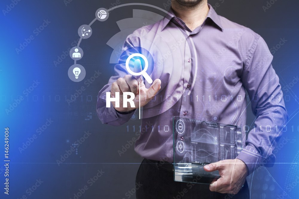 Business, Technology, Internet and network concept. Young businessman working on a virtual screen of the future and sees the inscription: HR Business, Technology, Internet and network concept. Young businessman working on a virtual screen of the future and sees the inscription: HR
